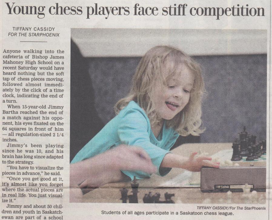 A young girl sticks her tongue out and reaches over at a chess timer to mark the end of her turn. This image is in the Star Phoenix newspaper in a story by Tiffany Cassidy about young chess players.
